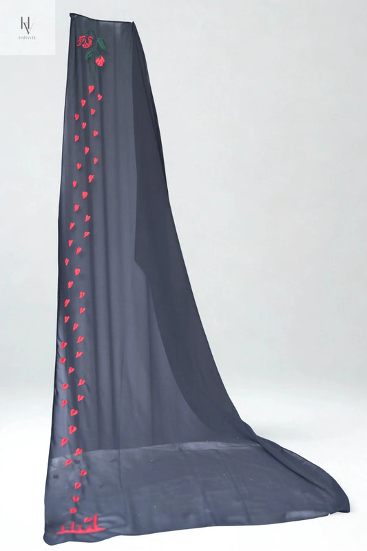 Dark gray scarf with red heart patterns on a white background